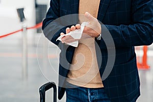 Keep your hands clean. Cropped shot of unrecognizable man disinfects hands with antibacterial napkin or antiseptic wet wipe during