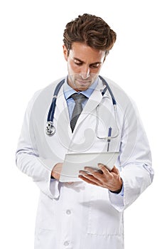 Keeping abreast of medicine with new technology. a serious-looking doctor looking at a clipboard he is holding.