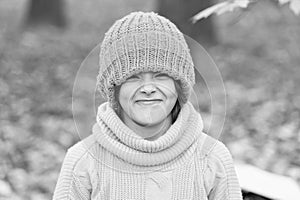 Keeping head warm in fall. Happy child wear knitted hat on autumn day. Small kid enjoy fall style. Little girl smile in