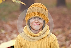 Keeping head warm in fall. Happy child wear knitted hat on autumn day. Small kid enjoy fall style. Little girl smile in