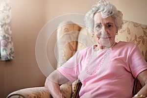 Keeping my older years comfortable. Portrait of a senior woman relaxing on a chair at home.