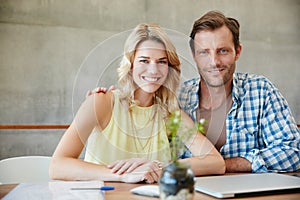 Keeping our home finances in check. Portrait of a happy couple doing their budgeting together at home.