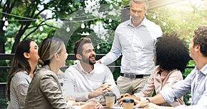 Keeping productivity on the high no matter where they work. a group of businesspeople having a meeting at a cafe.