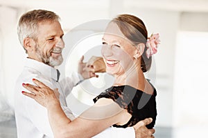 Keeping the romance alive. Shot of a mature couple dancing together in formal attire.