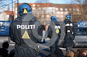 Keeping a watchful eye. Rearview shot of a police man in riot gear.