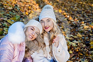 For keeping you warm through cold weather. Happy girls in warm clothes outdoors. Fall fashion