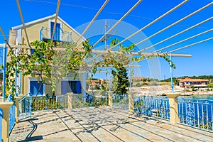 Traditional greek house with vine growing on terrace in Fiskardo village, Kefalonia island, Greece