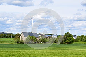 a farm with wind power plants and solar panels