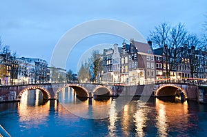 Keizersgracht inersection bridge view of Amsterdam canal and historical houses during twilight time, Netherland