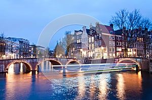 Keizersgracht intersection bridge view of Amsterdam canal and historical houses during twilight time, Netherland