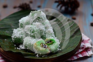 kelepon or klepon made from glutinous rice flour and filled with brownn sugar covered with grated coconut. indonesian food photo