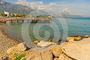 KEMER, TURKEY: Beautiful scenery on the pier on the beach and mountains on a sunny day.
