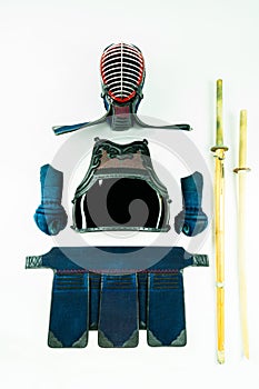 Kendo - Kendoka armor and equipment arranged and displayed on white background, with shinai and wooden sword.