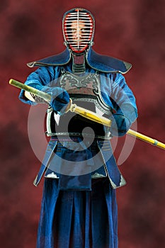 Kendo - Kendoka in full armor and bamboo sword. Studio shot.