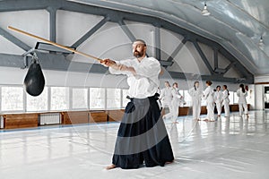 Kendo master practicing with wooden sword during break time on training