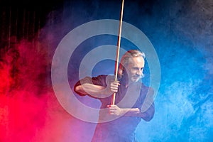 Kendo warrior in traditional dress on smoky background