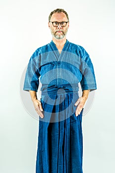 Kendoka - Man in kendo clothes, hakama and jacket. Studio shot on white background.