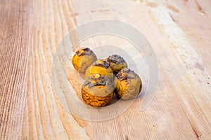 Kendu fruits are isolated on wooden surface