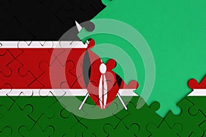 Kenya flag is depicted on a completed jigsaw puzzle with free green copy space on the right side