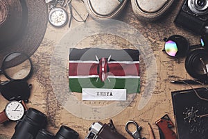 Kenya Flag Between Traveler`s Accessories on Old Vintage Map. Overhead Shot