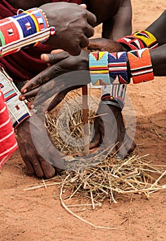 Kenya, Tsavo East - masai people setting the fire by their hands