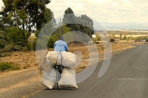 Kenyan cyclist taking home or delivering animal feed photo