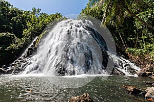 Kepirohi waterfall in the jungle with palm trees around, near Nan Madol, Pohnpei island, Federated states of Micronesia.