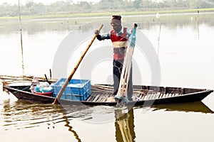 Kerala, India, January 10, 2018 Ã¢â¬â A local fisherman fishing with his fishing net on a rowing boat at a Kerala backwater area at