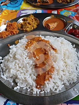 Kerala local meals with fish curry, thoran , chutney and pickle