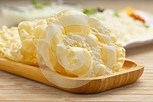 Kerala Papadum in wooden base ,close up