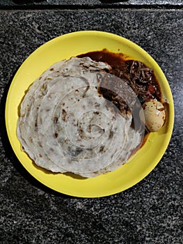 Kerala parathas / porotta / roti / parotta / barotta/ naan layered flatbread made from maida or whole wheat flour. Eat with spicy