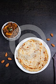 Kerala porotta and  mutton curry, layered flatbread