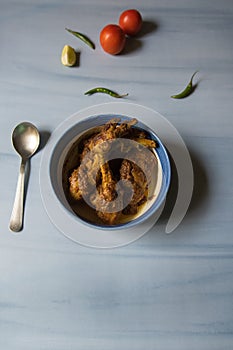 Kerala style chicken masala curry in a bowl on a background.