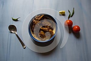 Kerala style chicken masala curry in a bowl on a background.