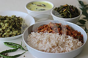 Kerala style veg meals including boiled matta rice, red carrot thoran, beans stir fry, green gram bottle gourd thoran and tempered