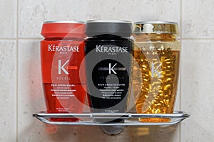 Kerastase Paris hair shampoo bottles closeup on bath stand.