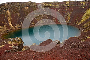 Kerid volcanic crater lake in the Grimsnes area, South Iceland with volcanic soil covered with moss