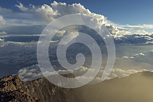 Kerinci volcano summit caldera in early morning high above the clouds in Sumatra, Indonesia