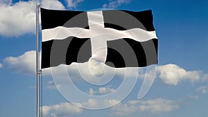 Kernow - Cornwall flag against background of clouds floating on the blue sky