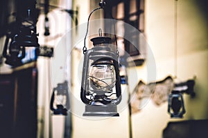 Kerosene lamp hanging on the street, old town, vintage photo