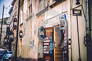 Kerosene lamp hanging on the street, old town, vintage photo
