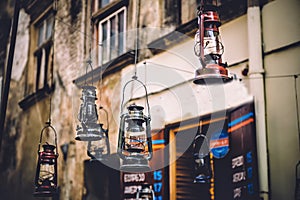 Kerosene lamp hanging on the street, old town, vintage photo