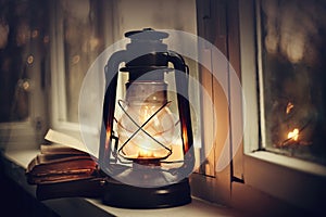 Kerosene lamp and old books