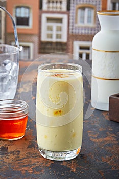 Kesar Saffron Lassi with honey served in glass isolated on table top view of punjabi culture