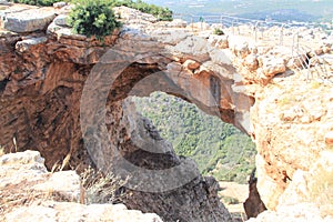 Keshet Cave - ancient natural limestone arch spanning the remains of a shallow cave with sweeping views near Shlomi
