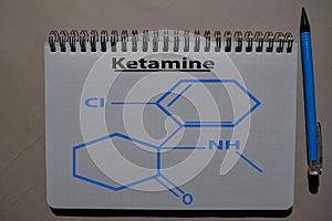 Ketamine write on a book. Structural chemical formula. Education concept