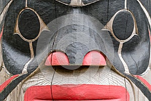 Ketchikan, Alaska, USA - May 22, 2023: Brightly painted face on Totem Pole