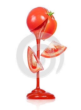 Ketchup flows from a fresh tomato isolated on white background