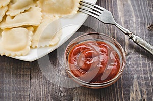 Ketchup in glass and dumpling in a plate/ketchup in glass and dumpling in a plate top view