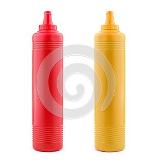 Ketchup and mustard bottles on white photo
